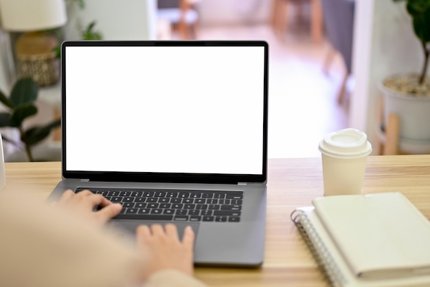 Backview Businesswoman using laptop computer typing on keyboard closeup image