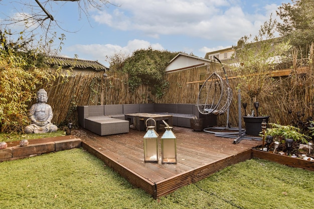 A backyard with a wooden deck and a large couch