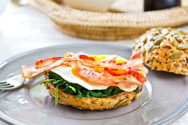 Bacon ,Fried egg and steamed spinach on Pumpkin bread breakfast