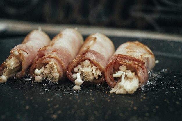 Bacon rolls in a frying pan