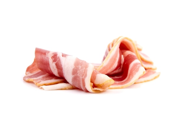 Bacon strips for scrambled eggs raw smoked pork meat slices isolated on white background