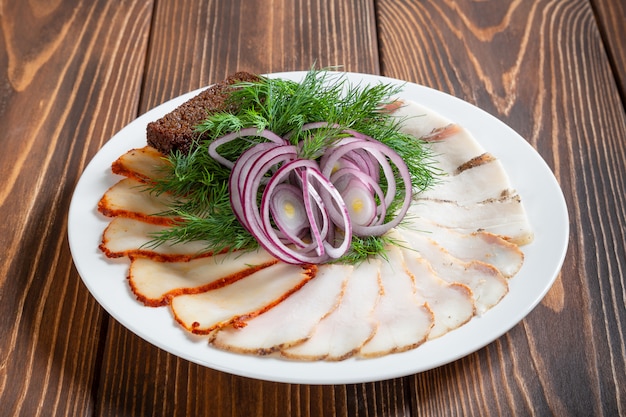 Bacon with russian toasts of black bread and red onion