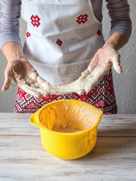 Bad dough. Kitchen disaster and bad cooking concept. Upset woman keeps sticky dough