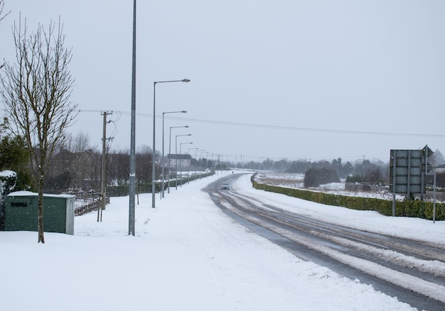 Bad driving condition with road covered in snow.