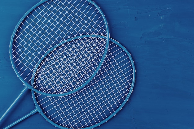 Badminton rackets on classic blue