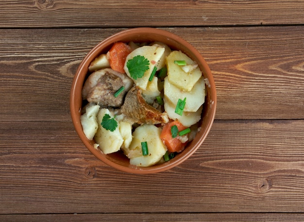 Baeckeoffe - ypical dish from  French , Germany.mix of sliced potatoes, sliced onions, cubed mutton, beef and pork