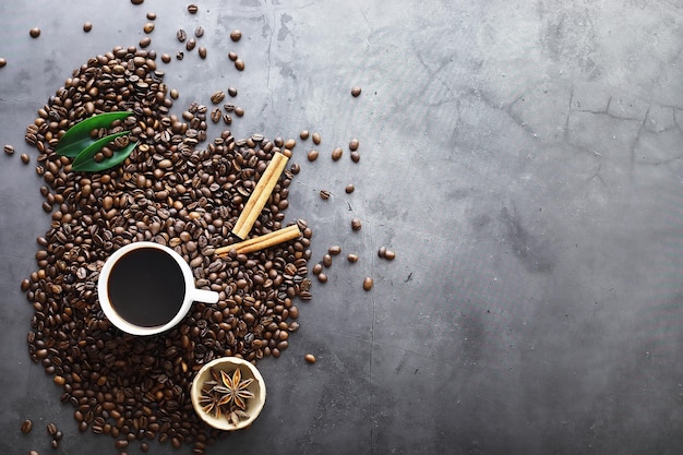 Bag of coffee. Coffee beans roasted on the table. Coffee beans with green leaves for cooking.