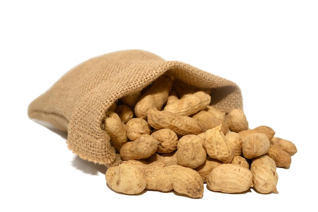 A bag of dry peanuts in burlap on a white background Delicious nut