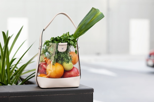 A bag of fresh fruit and vegetables sits on a bench. Beauty, health, healthy lifestyle.