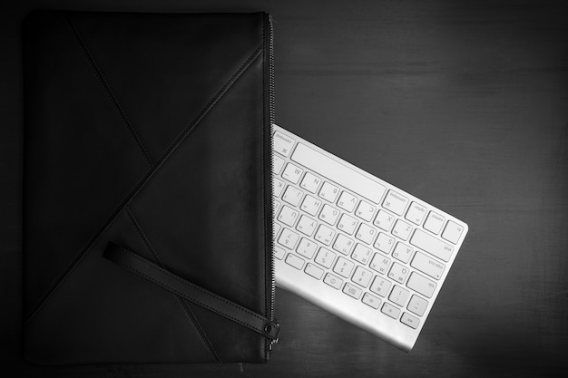 A bag and keyboard are placed under the vintagetextured floor