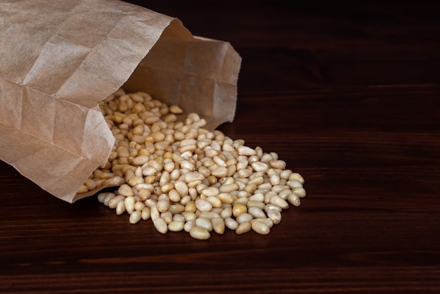 Bag of pine nuts on wooden table