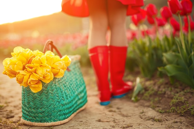 Bag with flowers near anonymous female