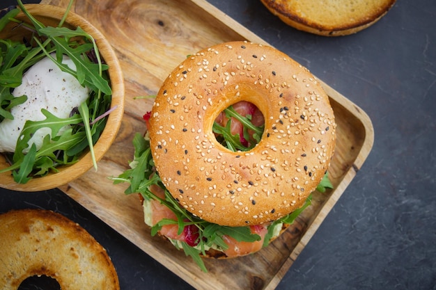 Bagel with salmon on a dark background, Breakfast bun