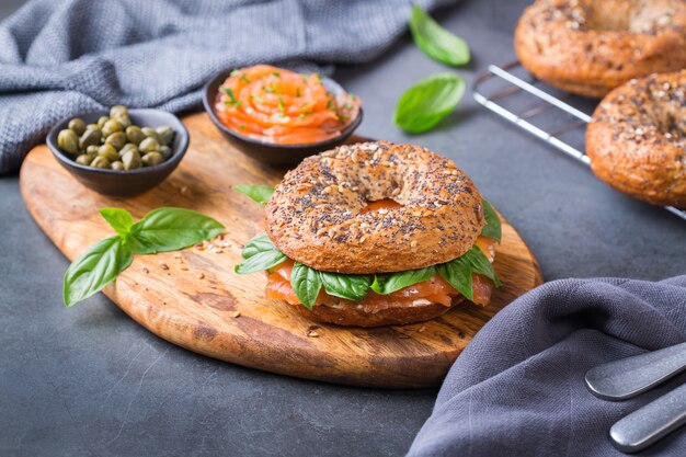 Bagels with smoked salmon, cream cheese and capers on a table. Food, lunch, brunch, meal on a plate, plating concept