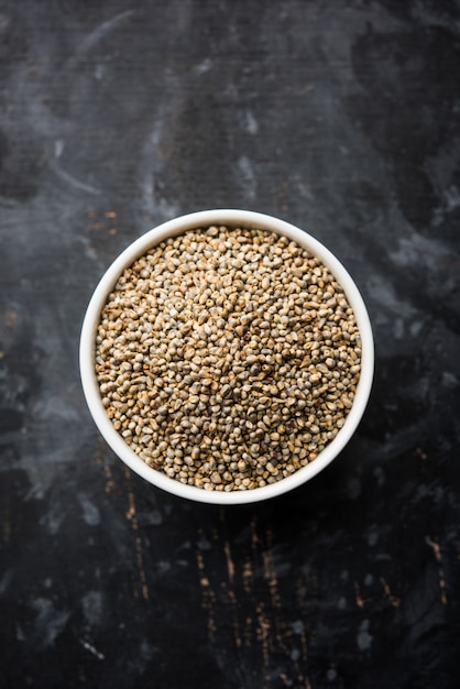 Bajra or pearl millet or sorghum grains in a bowl, selective focus