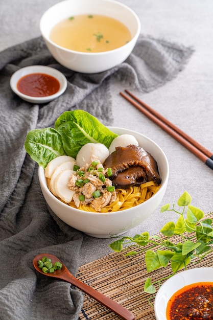 Bak chor mee The noodles are tossed in vinegar minced meat pork slices pork liver stewed sliced mushrooms meat balls and bits of deepfried lard