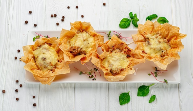 Bake a julienne pie in a basket with cheese chicken and mushrooms Serving food in a restaurant Photo for the menu