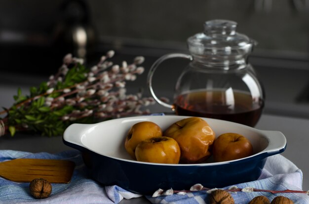 Baked apples, walnuts and tea. Still life.