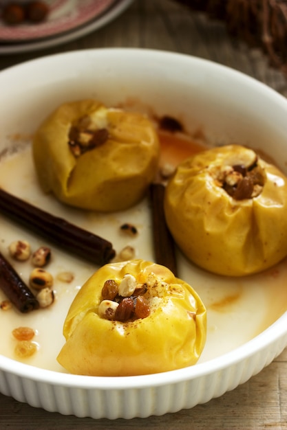 Baked apples with raisins, hazelnuts and cinnamon 