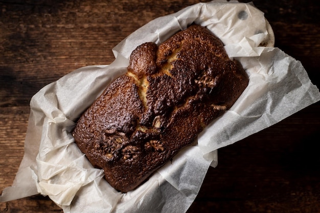 Baked banana bread Dark wooden background A whole freshly made loaf of bread