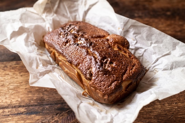 Baked banana bread Dark wooden background A whole freshly made loaf of bread