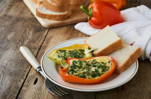 Baked bell pepper with egg and parsley on a plate