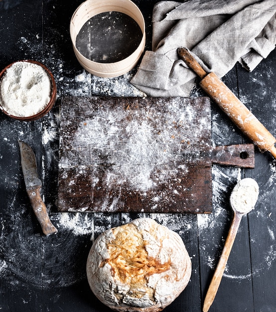 Baked bread, white wheat flour, wooden rolling pin