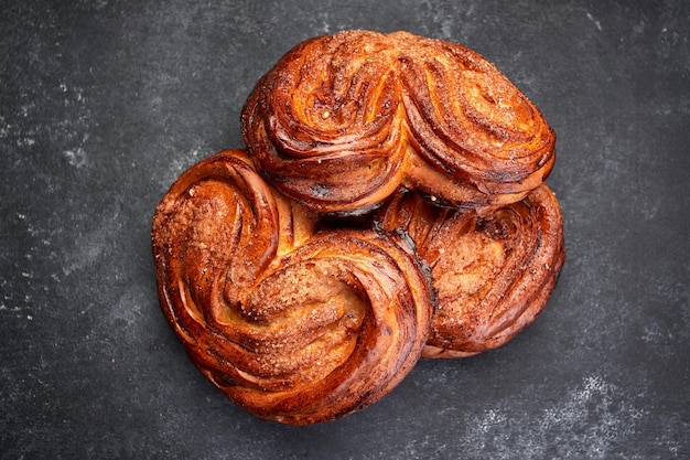 Baked buns with sugar on gray concrete