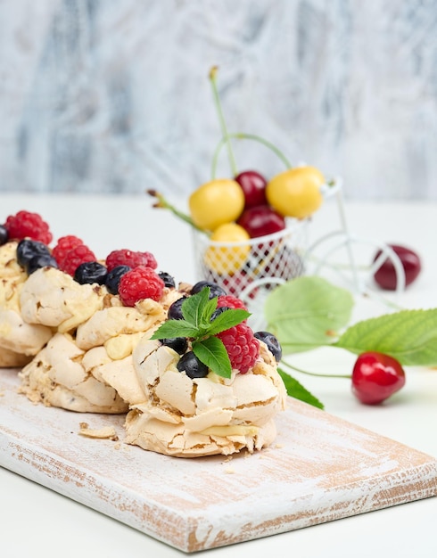 A baked cake made from whipped chicken protein and cream decorated with fresh berries