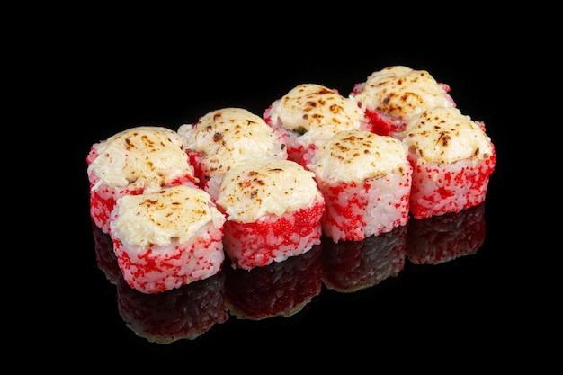 Baked California roll with flying fish roe on black background with reflection