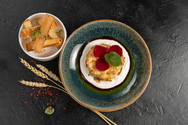 Baked camembert in almonds with berry sauce and wheat croutons