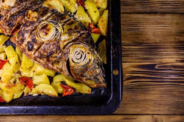 Baked carp fish with the potatoes and bell pepper Top view