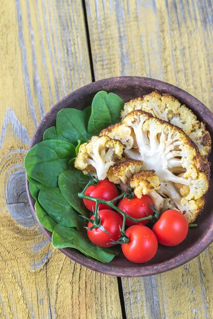 Baked cauliflower with tomatoes and spinach