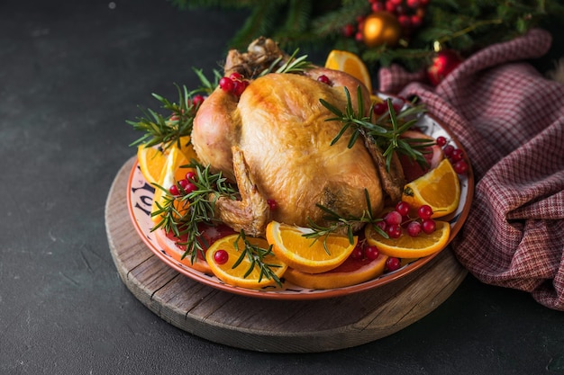 Baked  chicken. The Christmas table is served with a turkey, decorated with bright fruits. Christmas dinner.