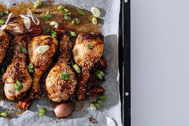 Baked chicken drumsticks with sesame honey and soy sauce onion and spices