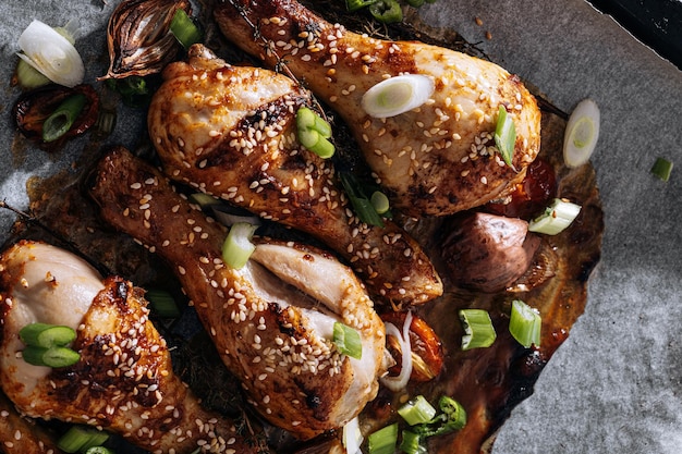 Baked chicken drumsticks with sesame honey and soy sauce onion and spices