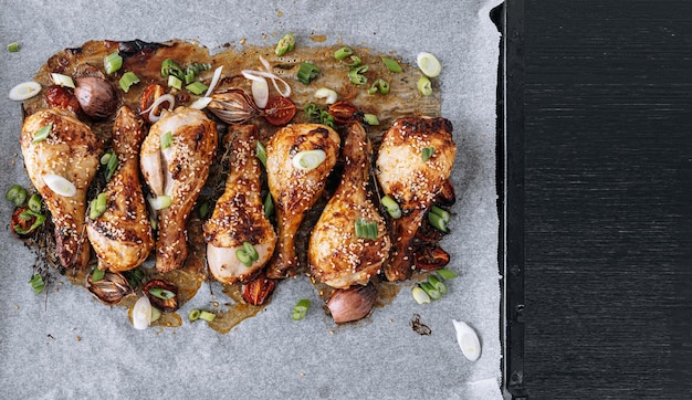 Baked chicken drumsticks with sesame honey and soy sauce onion and spices