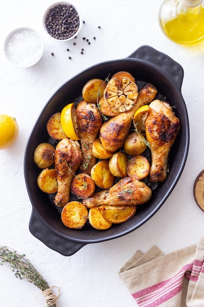 Baked chicken legs with potatoes and lemon Recipe