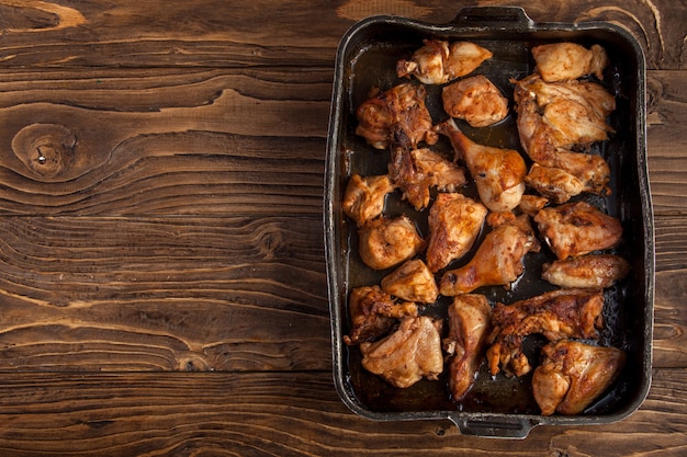 Baked chicken pieces on baking sheet