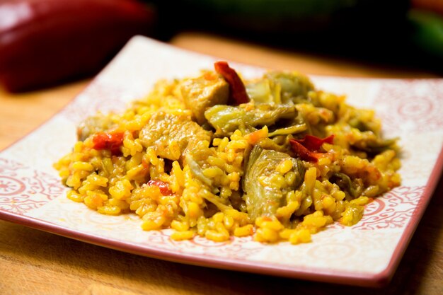 Baked chicken rice paella with vegetables. Traditional Spanish recipe.