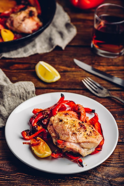 Baked chicken thighs with red bell peppers and lemon