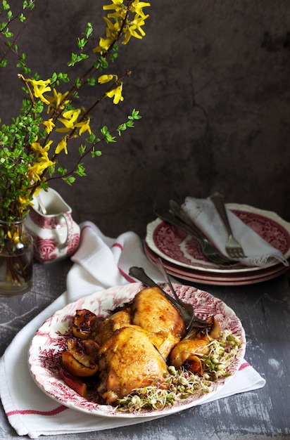 Baked chicken with apples, served with sprouted seeds and sauce.