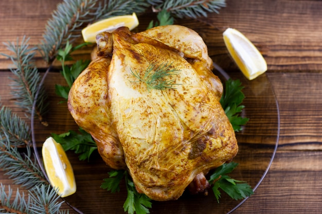 Baked chicken on wooden. Festive lunch for the holidays. Cooked chicken at home