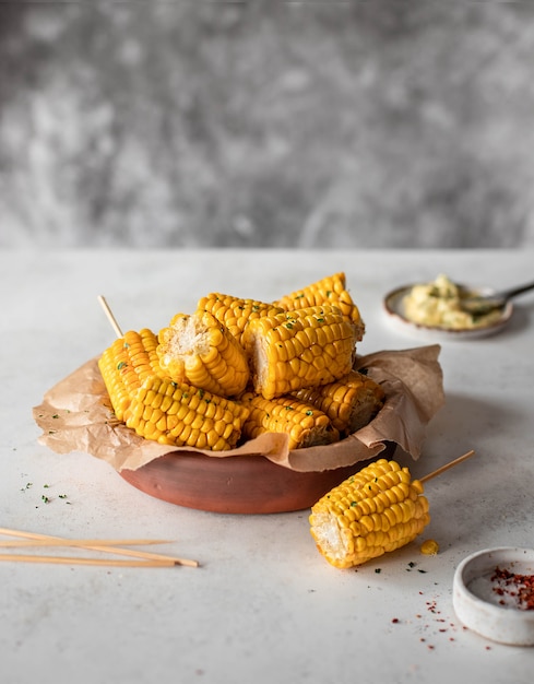 baked corn with garlic butter on a gray background