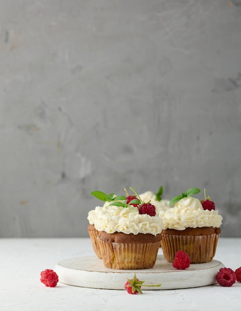 Baked cupcakes with white butter cream on the table delicious dessert