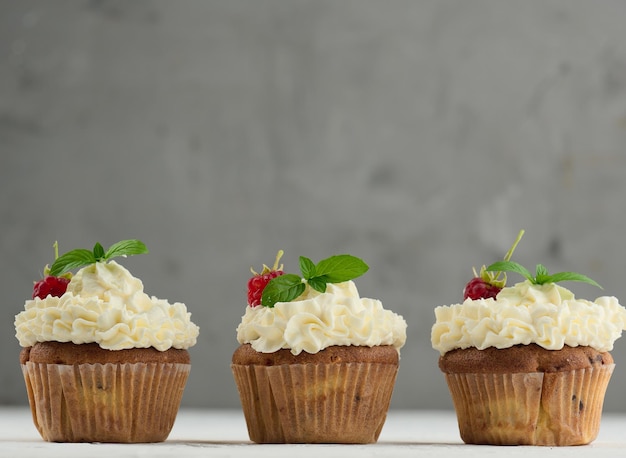 Baked cupcakes with white butter cream on the table delicious dessert