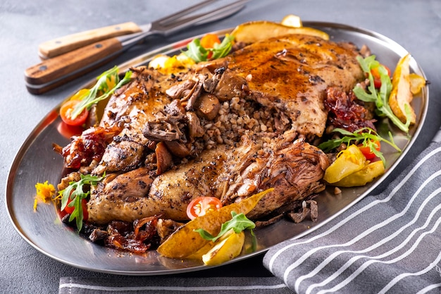 Baked duck stuffed buckwheat porridge and vegetables