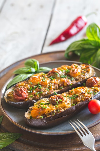 Baked eggplant. aubergine stuffed with vegetables and cheese