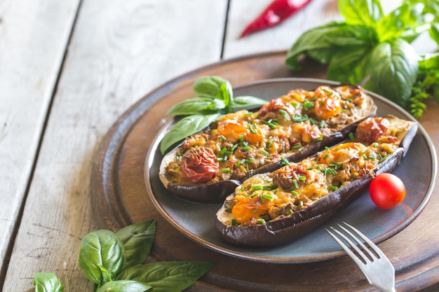 Baked eggplant. aubergine stuffed with vegetables and cheese