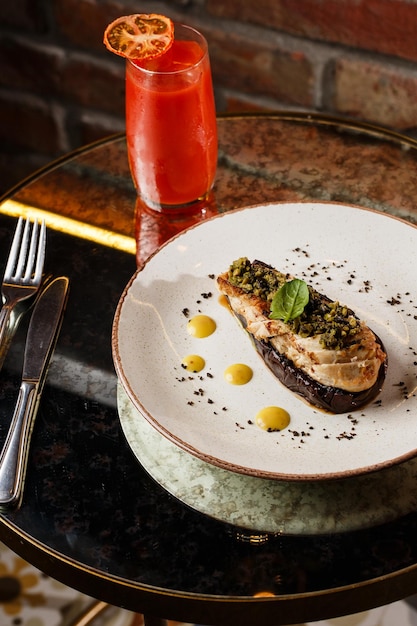 Baked eggplant stuffed with grilled chicken tomatoes and spices on white plate Traditional dish Karniyarik of turkish cuisine View from above